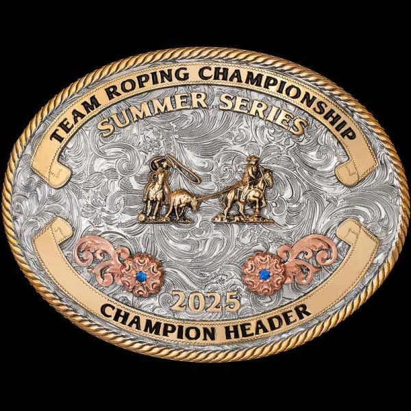 "Our Aledo Buckle will make your Team Ropers fall Head over Heel-er! This Buckle is crafted on a German Silver base with a natural finish. It is detailed with many elements to add character & color such as a Jeweler's Bronze rope edge, Banners wi